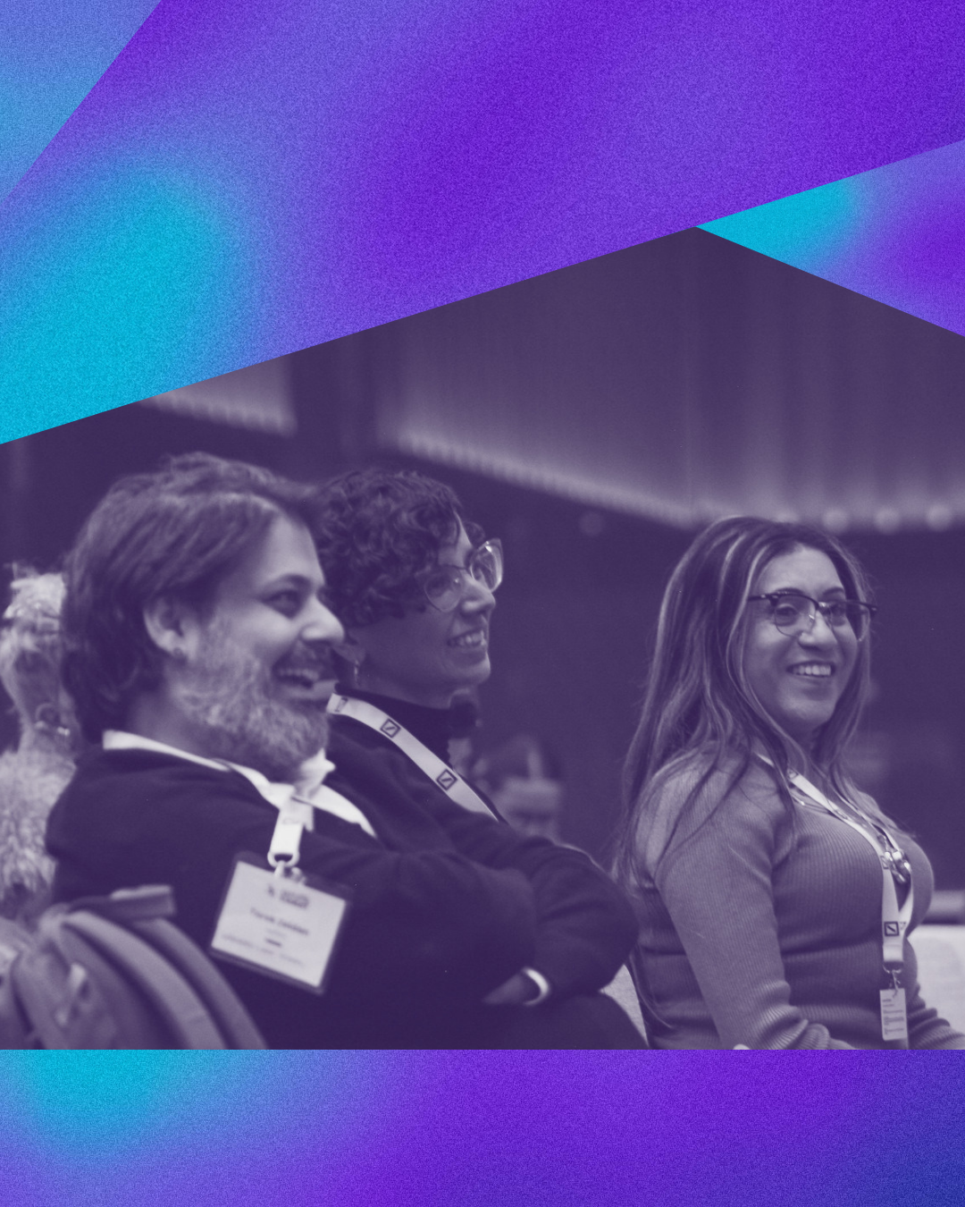 Three attendees laughing together in the audience at a previous Outsummit