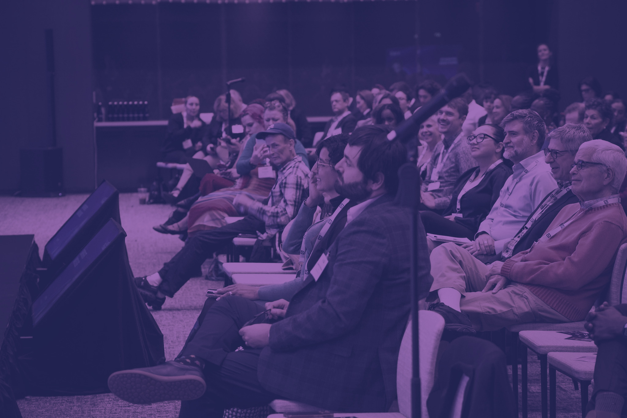 Attendees listening during a session at a previous Outsummit